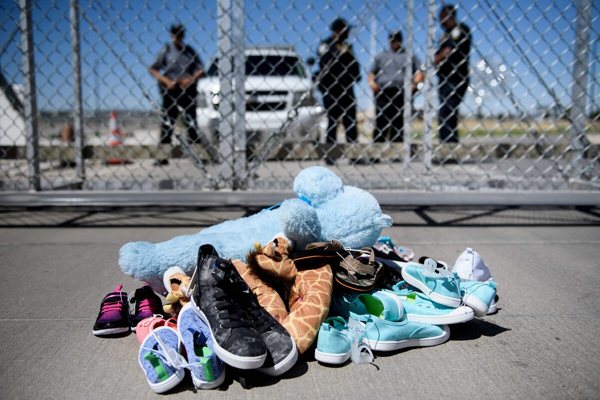 Border fence with children's belongings